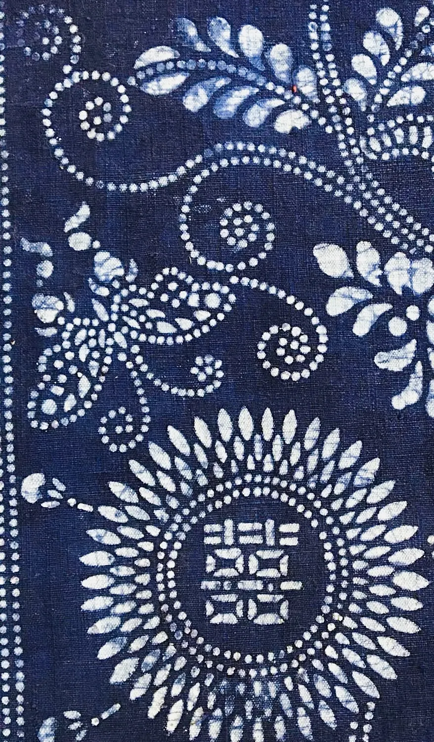 Dark indigo study fragment with dense dotted and medallion-like resist motifs.