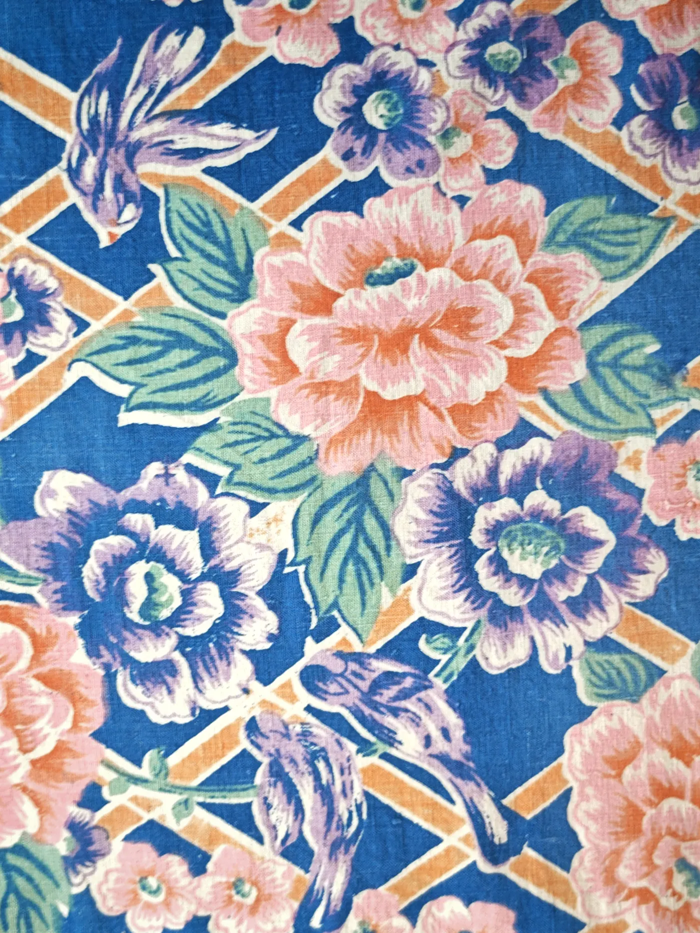 Blue-ground Chinese folk print with a large pink peony, green leaves, orange lattice and a stylised bird.